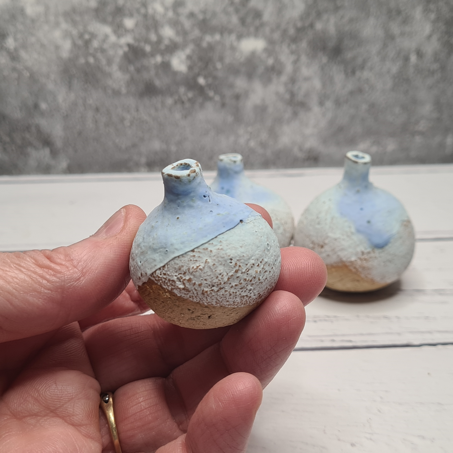 Three Tiny Overlapped Stoneware Bottles